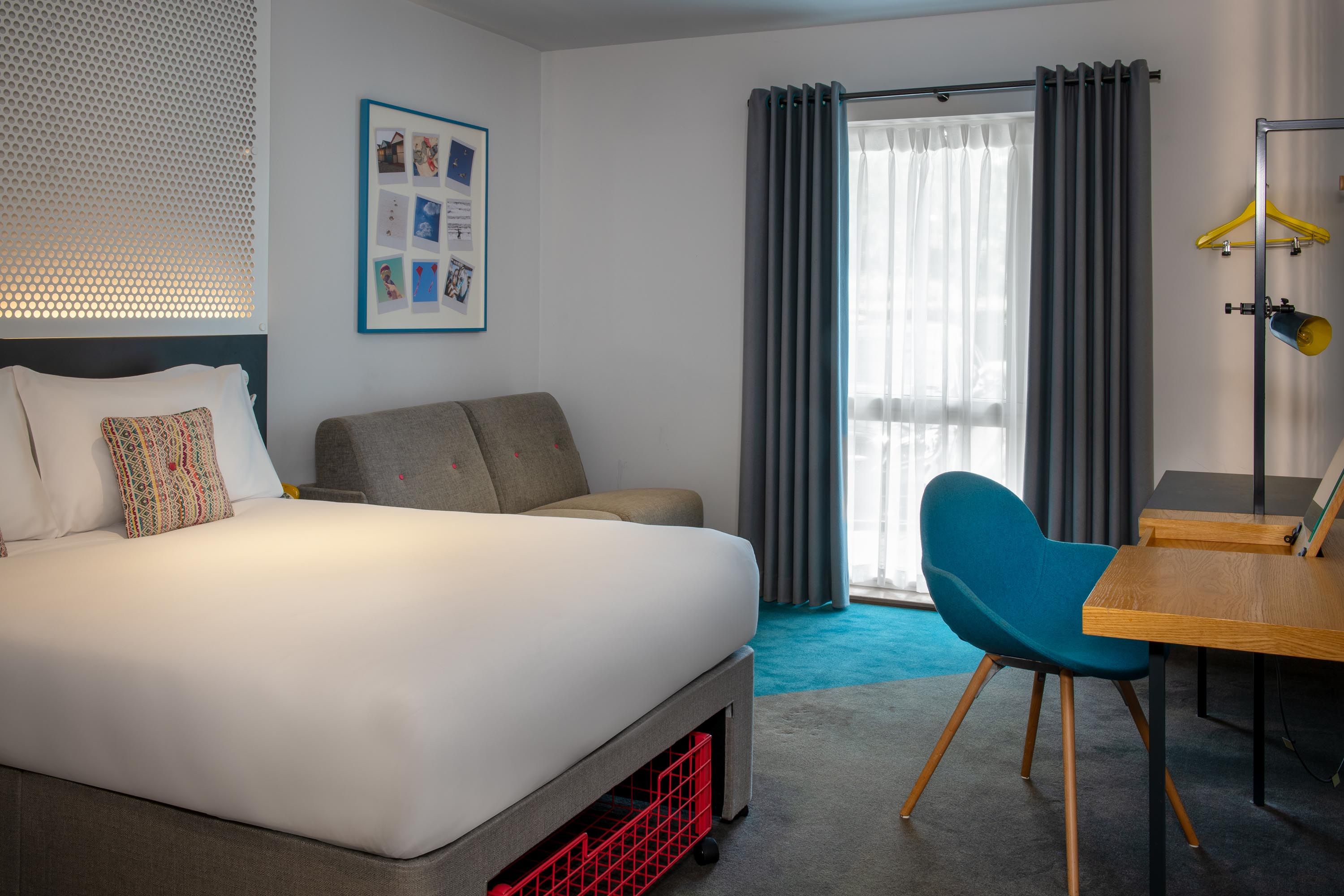 Standard family double bed with sofa and desk with blue chair