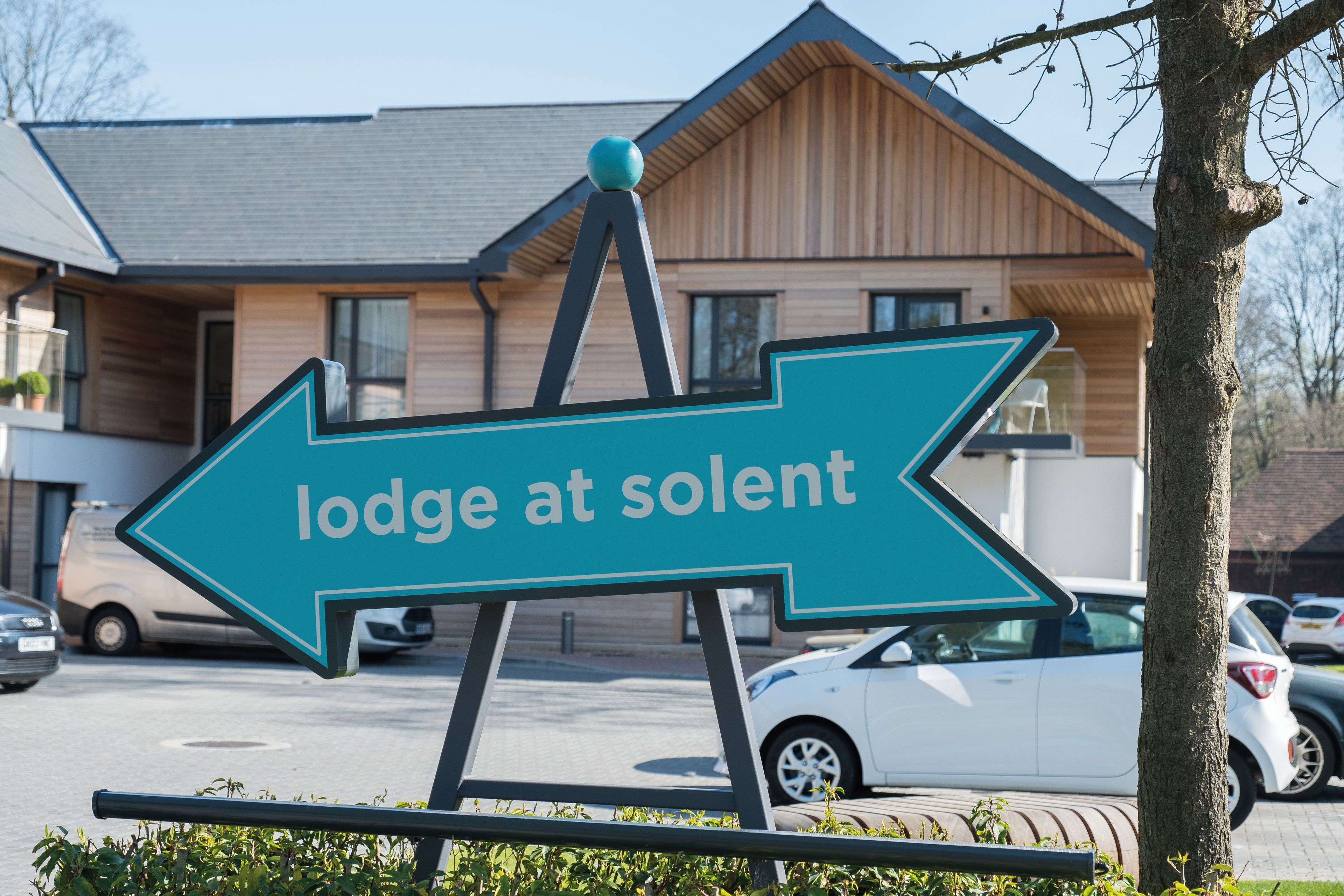 Lodge at Solent blue arrow sign