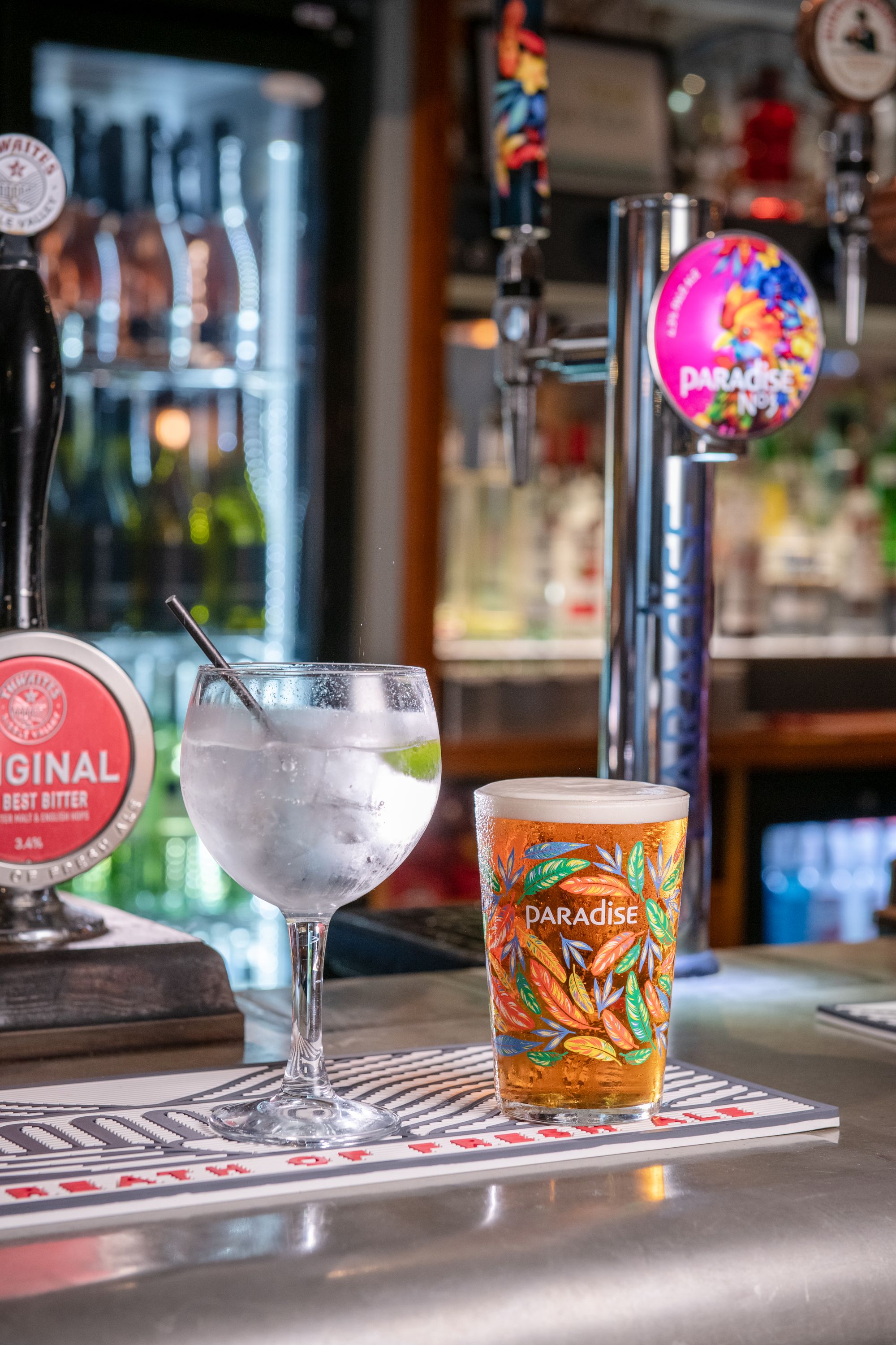 Pint of paradise and gin and tonic drinks on the bar
