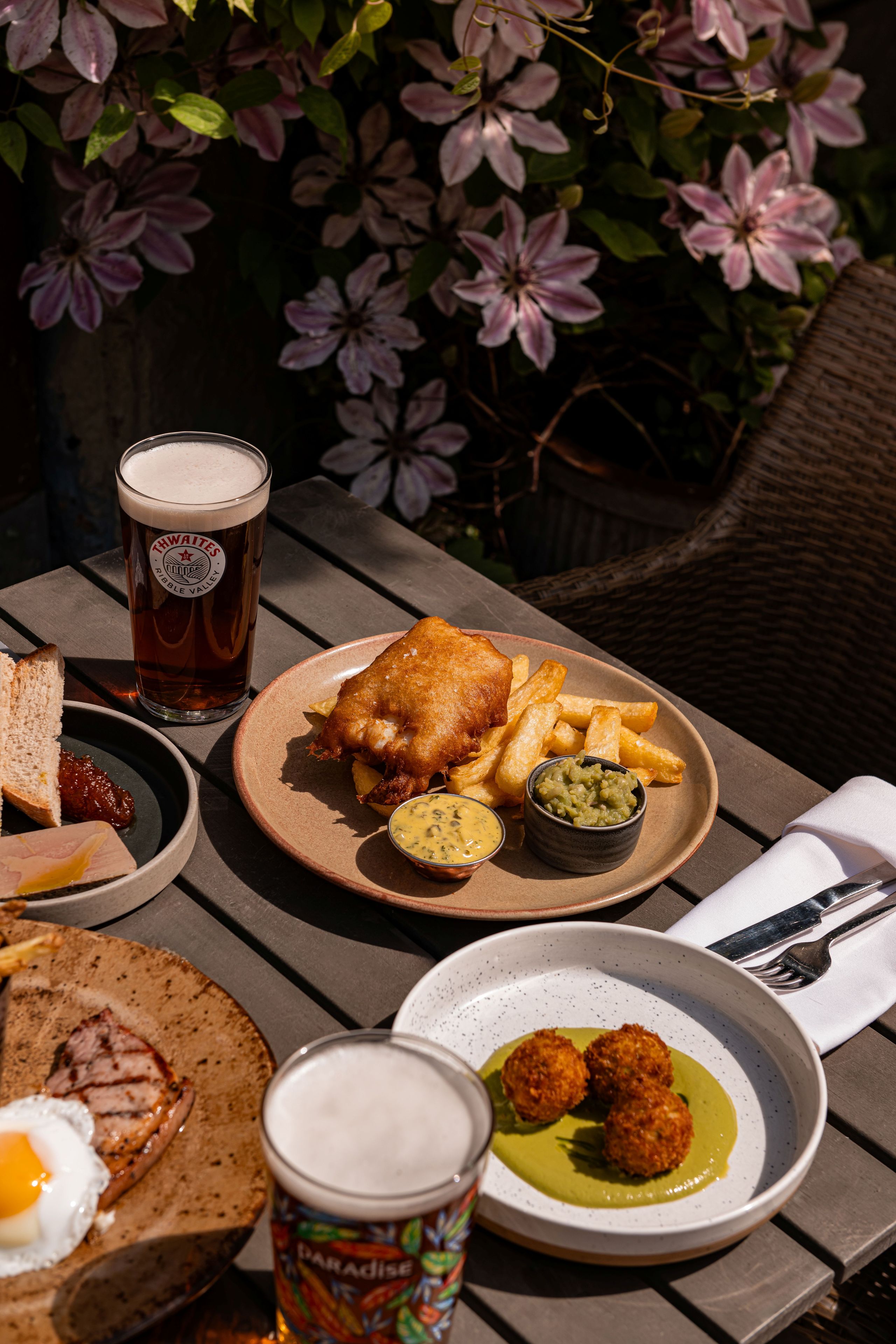 fish and chips dish with a pint of thwaites ale